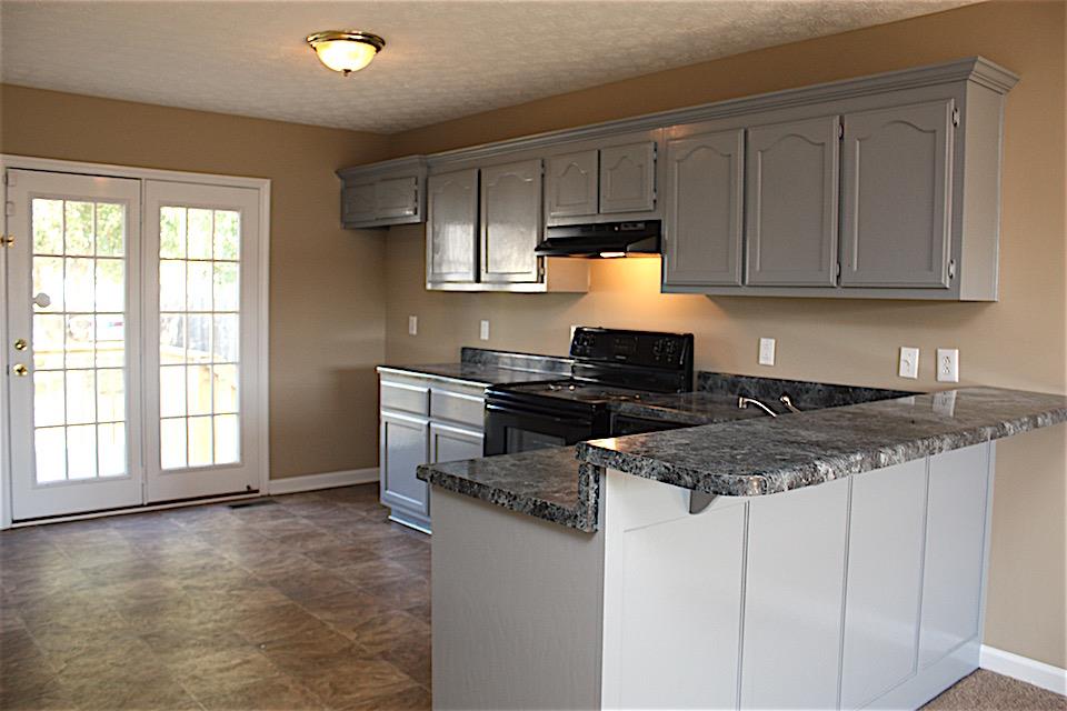 327 Bandera Lane Springfield, TN 37172 - Photo 5 of 11 a kitchen with stainless steel appliances granite countertop a stove a sink and a refrigerator