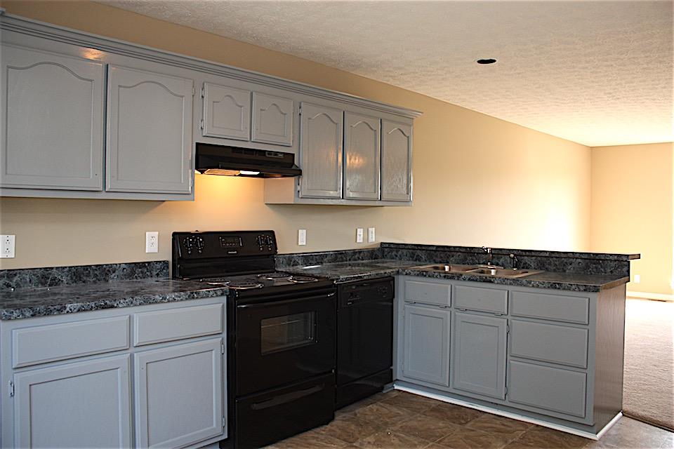 327 Bandera Lane Springfield, TN 37172 - Photo 6 of 11 a kitchen with granite countertop a stove sink and cabinets