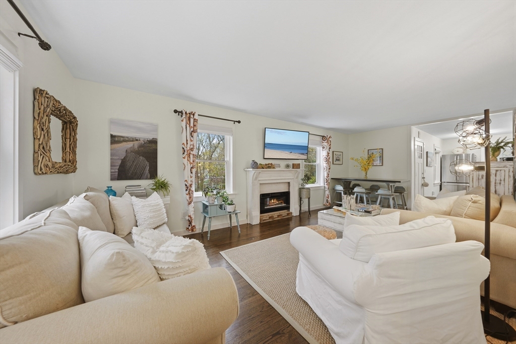 55 Ridgeview Drive Falmouth, MA 02540 - Photo 21 of 32 a living room with furniture a fireplace and a flat screen tv