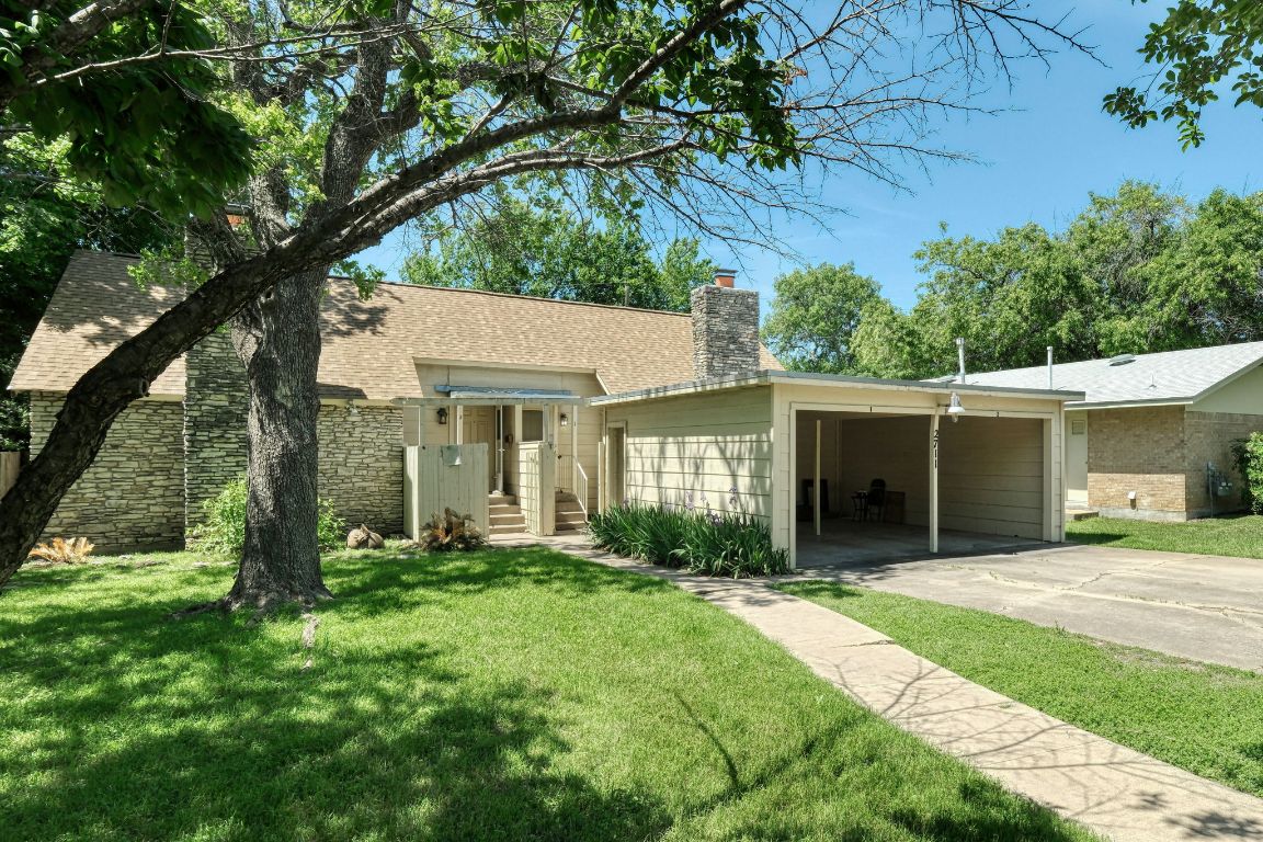2711 St Edwards Circle, Unit 2 Austin, TX 78704 - Photo 1 of 17 View of front of property with a chimney, a front yard, driveway, and a shingled roof