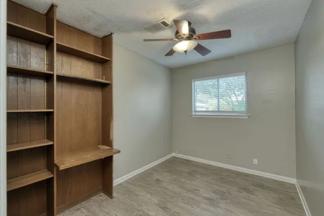 a view of room with window and ceiling fan