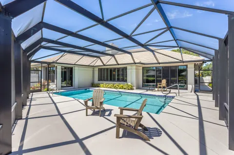 a view of backyard with a patio and dining table and chairs