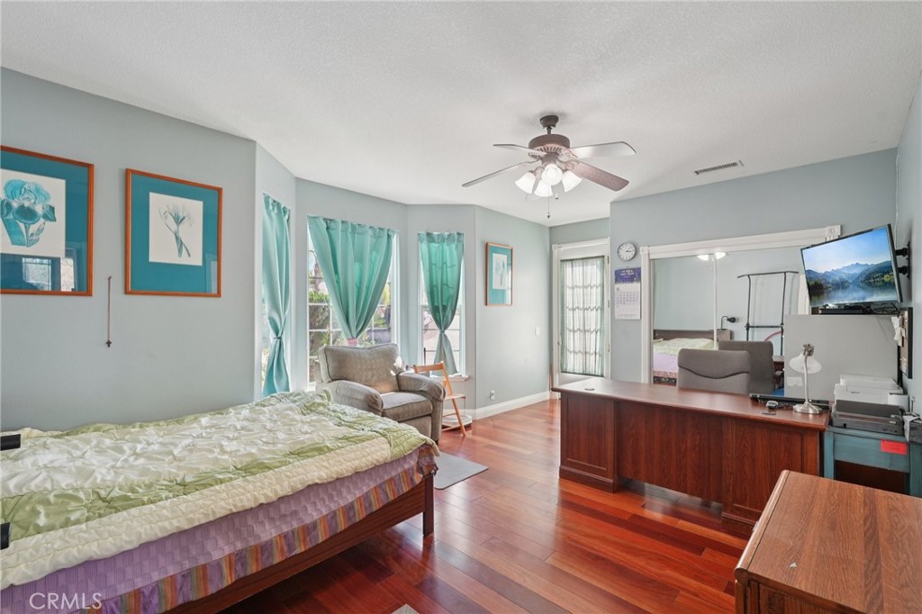 30810 Avenida Del Reposo Temecula, CA 92591 - Photo 12 of 75 a spacious bedroom with a large bed a chandelier and windows