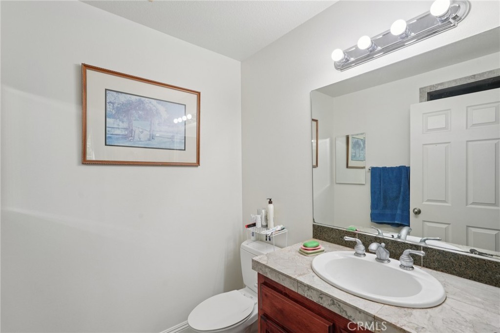 30810 Avenida Del Reposo Temecula, CA 92591 - Photo 14 of 75 a bathroom with a toilet a sink and mirror