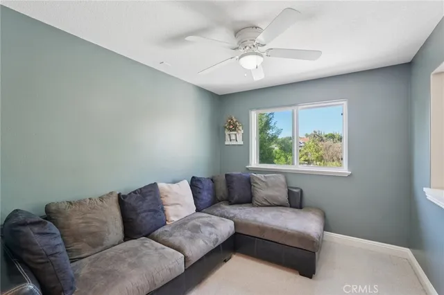 a view of a hallway with wooden floor and windows