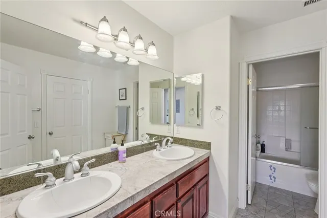 a spacious bathroom with a tub sink and mirror