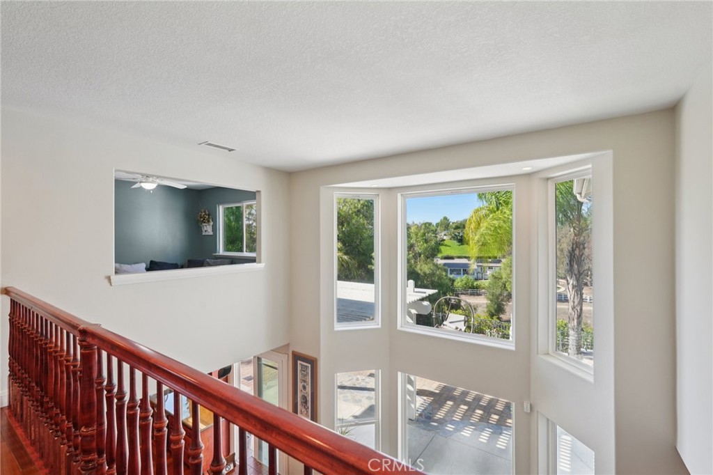 30810 Avenida Del Reposo Temecula, CA 92591 - Photo 27 of 75 a view of a hallway with wooden floor and windows