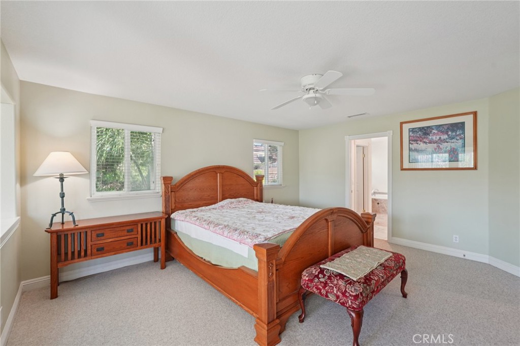 30810 Avenida Del Reposo Temecula, CA 92591 - Photo 30 of 75 a bedroom with a bed and a chandelier