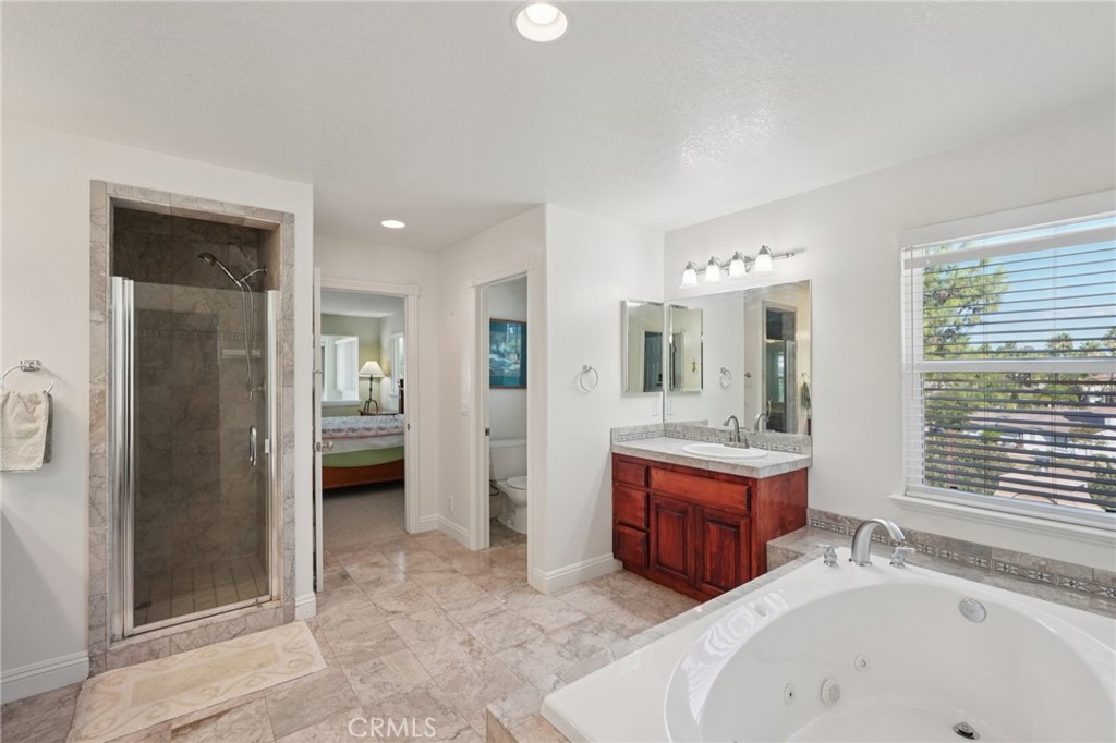 30810 Avenida Del Reposo Temecula, CA 92591 - Photo 34 of 75 a spacious bathroom with a tub sink and mirror