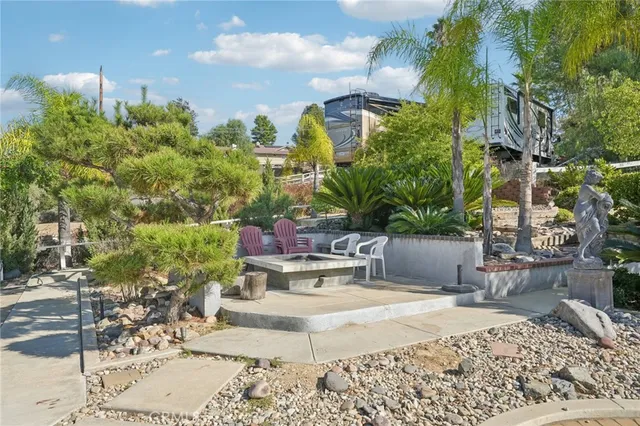 an aerial view of a house with a garden and lake view