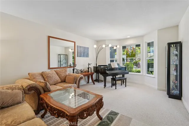 a dining room with furniture a chandelier and wooden floor