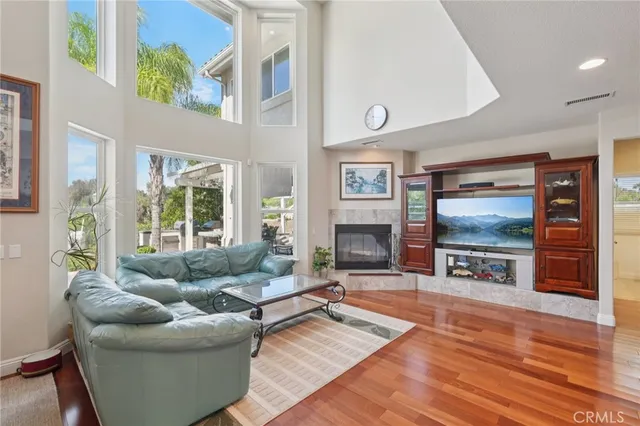 a kitchen with stainless steel appliances granite countertop a stove top oven a sink dishwasher and cabinets with wooden floor