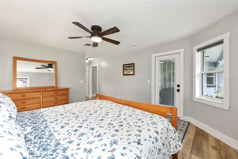 a bedroom with a large bed and a dresser