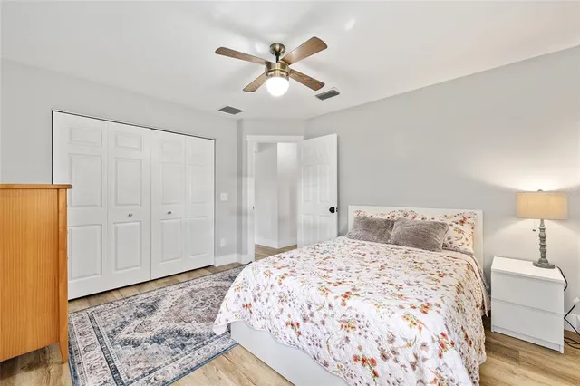 a bedroom with a large bed and a chandelier