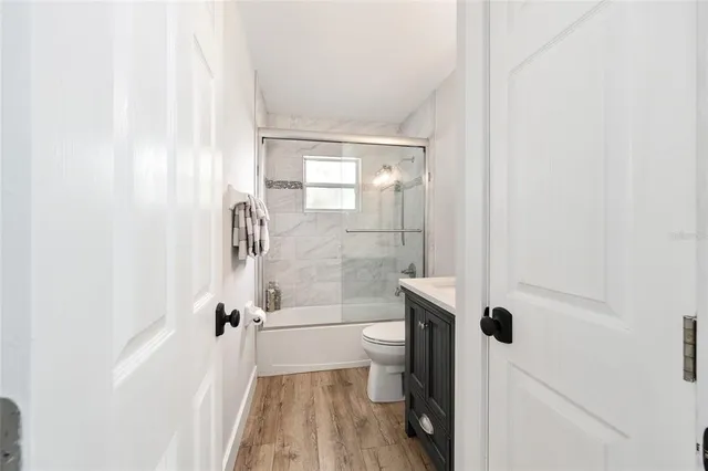 a bathroom with a shower a toilet and a shower