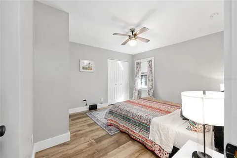 a bedroom with a bed and wooden floor