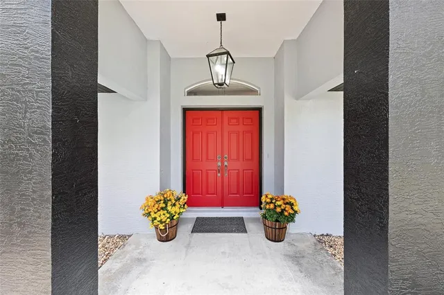 a view of a house with a yard and large tree