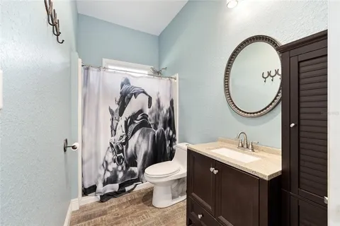 a view of a swimming pool with lawn chairs under an umbrella