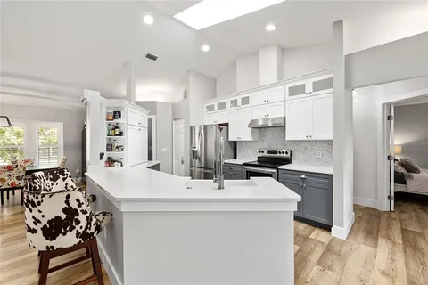 a kitchen with stainless steel appliances a sink stove and refrigerator