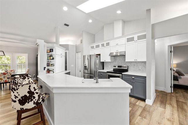 a kitchen with stainless steel appliances a sink stove and refrigerator