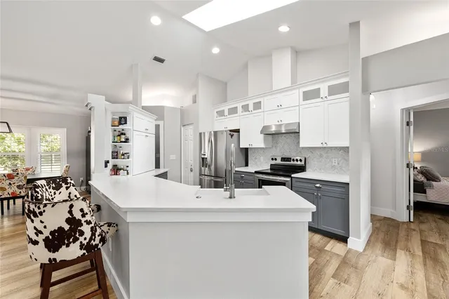 a kitchen with stainless steel appliances a sink stove and refrigerator