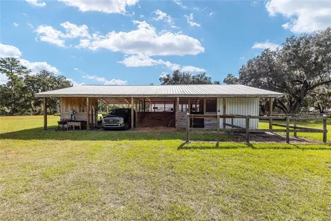 a view of a house with swimming pool and sitting area