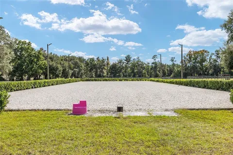 an aerial view of house with yard and swimming pool