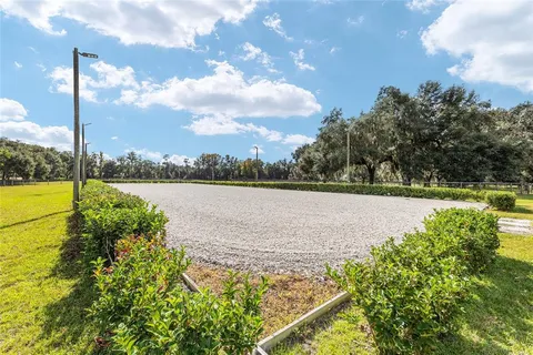 an aerial view of a house with a yard and swimming pool