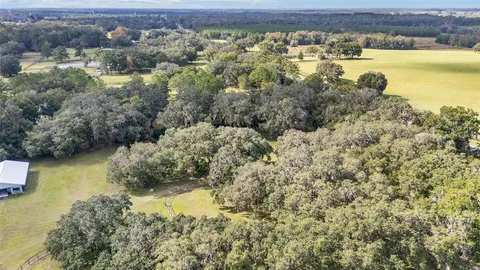 a aerial view of residential houses with yard and swimming pool