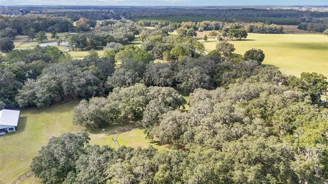 a aerial view of residential houses with yard and swimming pool