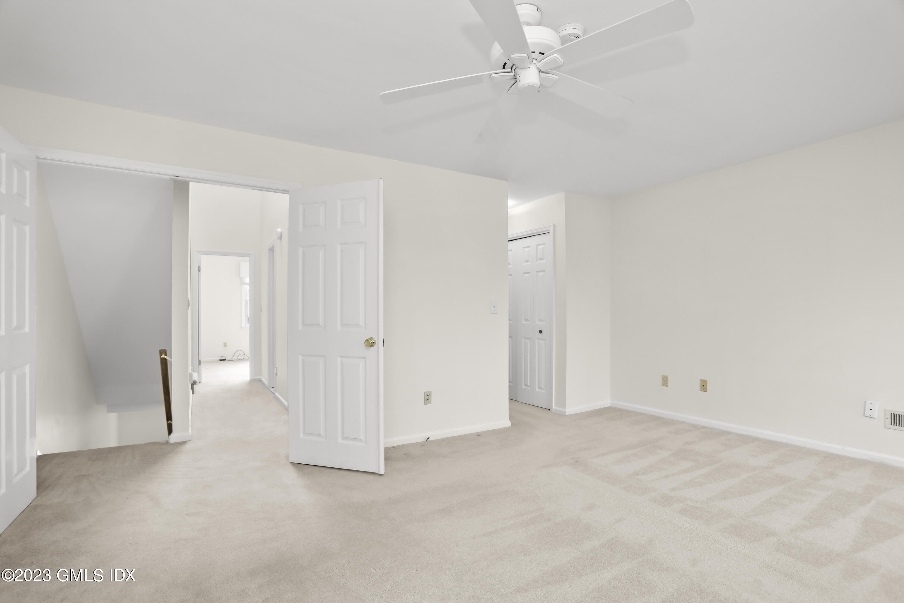5 Glen Street, Unit 101 Greenwich, CT 06830 - Photo 14 of 37 an empty room with a ceiling fan and carpet