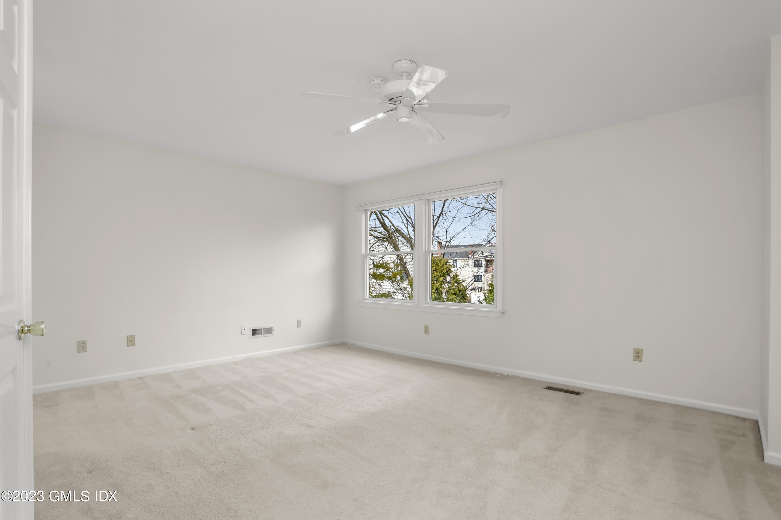 5 Glen Street, Unit 101 Greenwich, CT 06830 - Photo 15 of 37 an empty room with window and ceiling fan