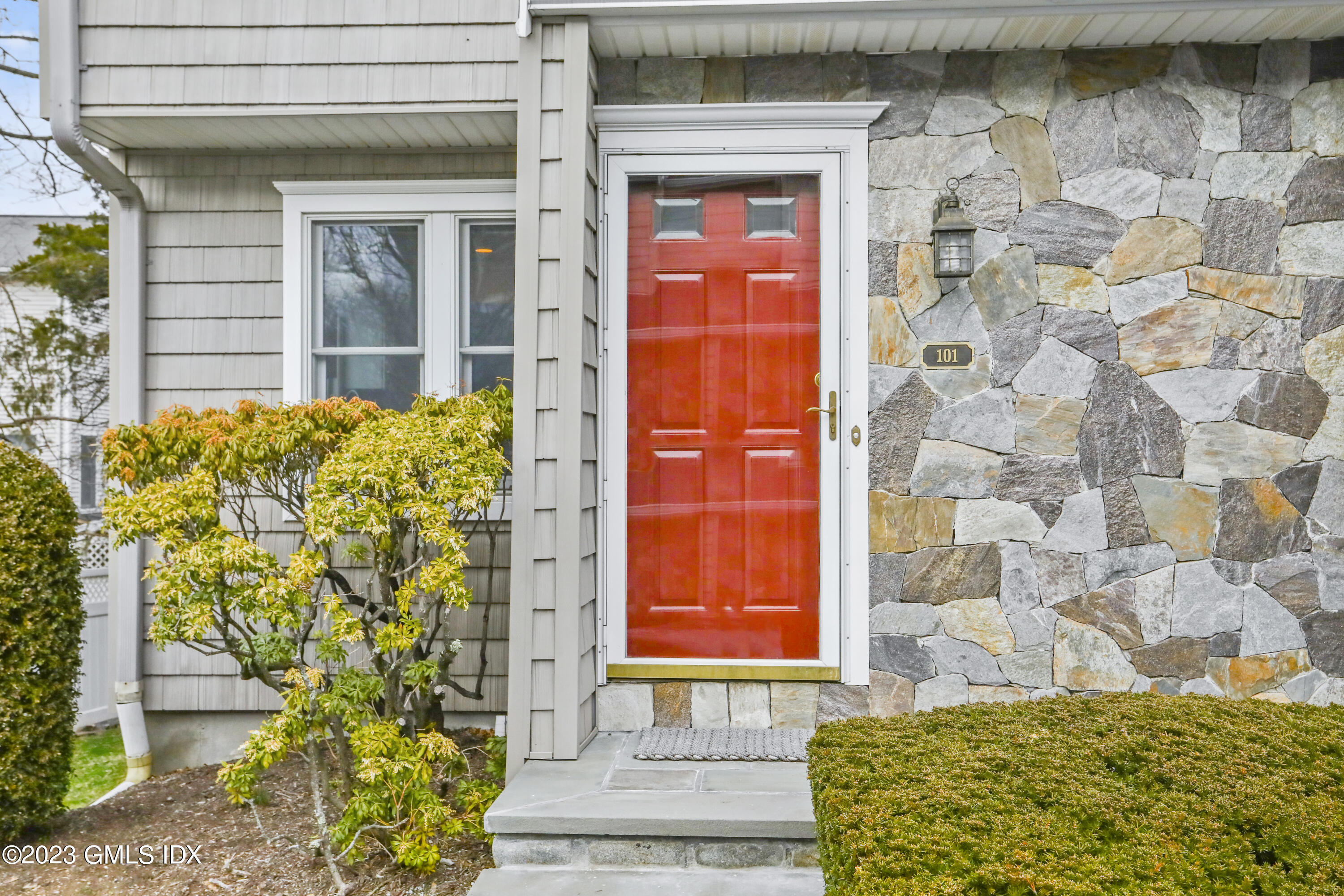 5 Glen Street, Unit 101 Greenwich, CT 06830 - Photo 2 of 37 a front view of a house with a garden