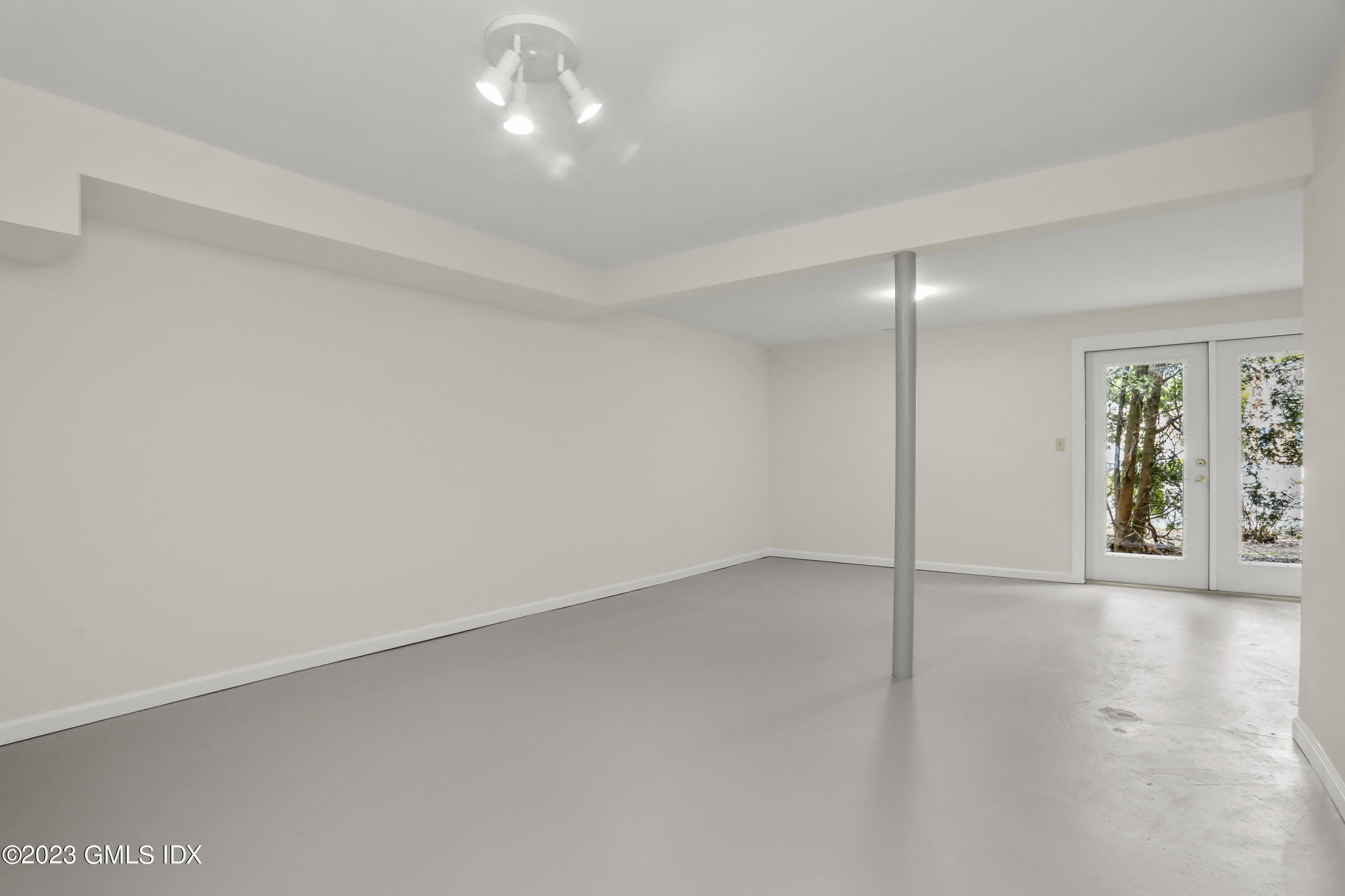 5 Glen Street, Unit 101 Greenwich, CT 06830 - Photo 25 of 37 an empty room with chandelier fan and windows