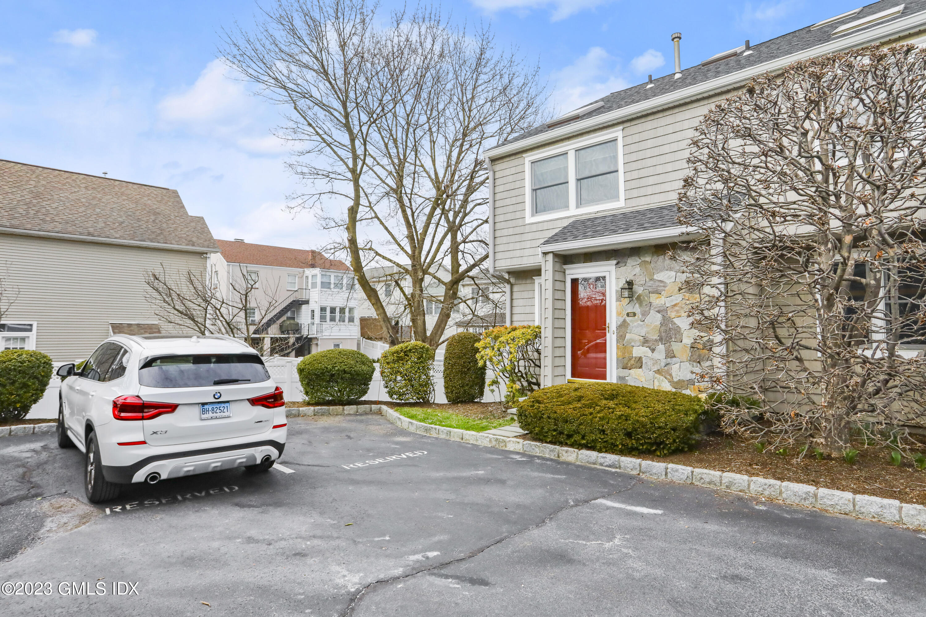 5 Glen Street, Unit 101 Greenwich, CT 06830 - Photo 29 of 37 a white car parked in front of a brick house