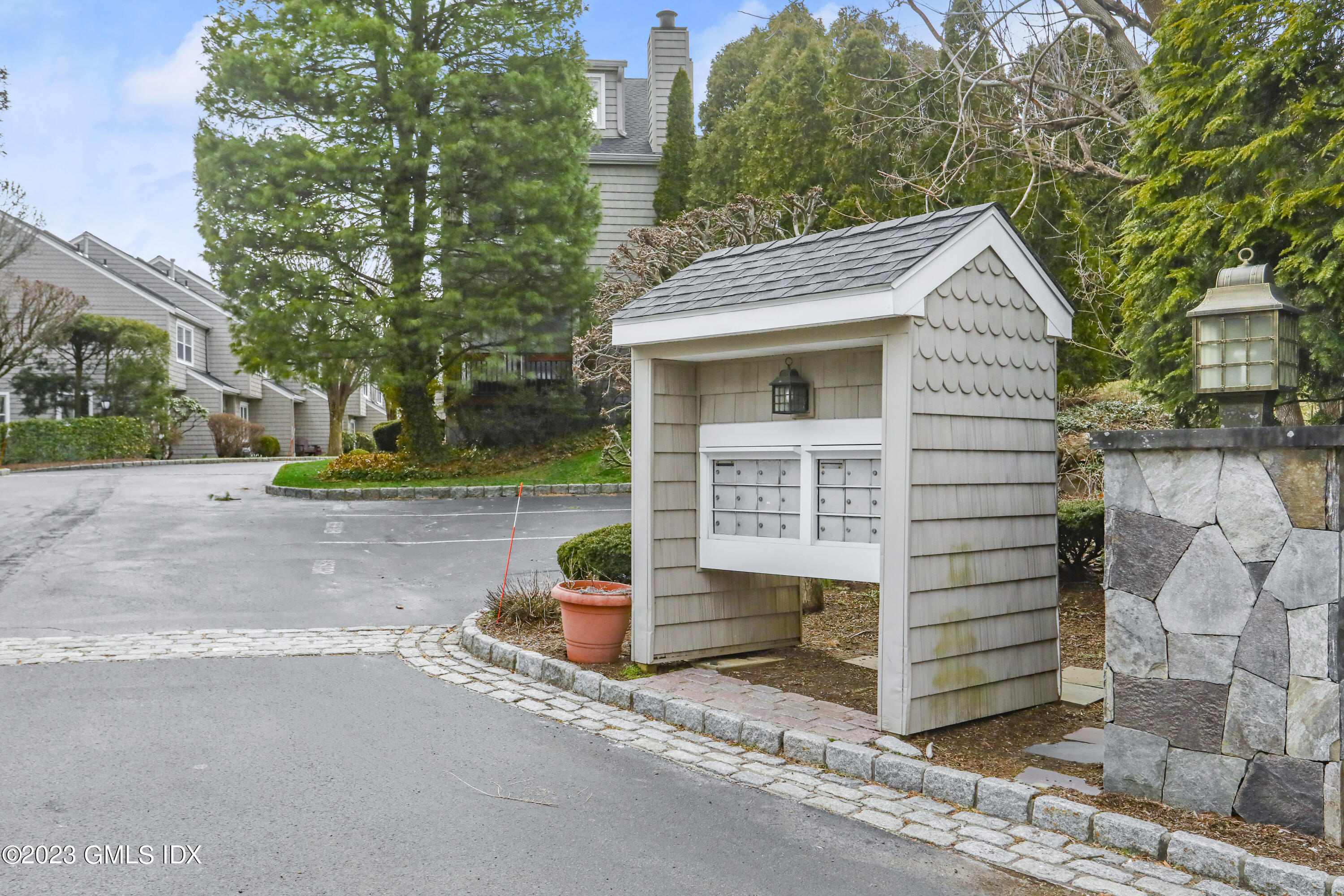 5 Glen Street, Unit 101 Greenwich, CT 06830 - Photo 33 of 37 a front view of a house with a yard