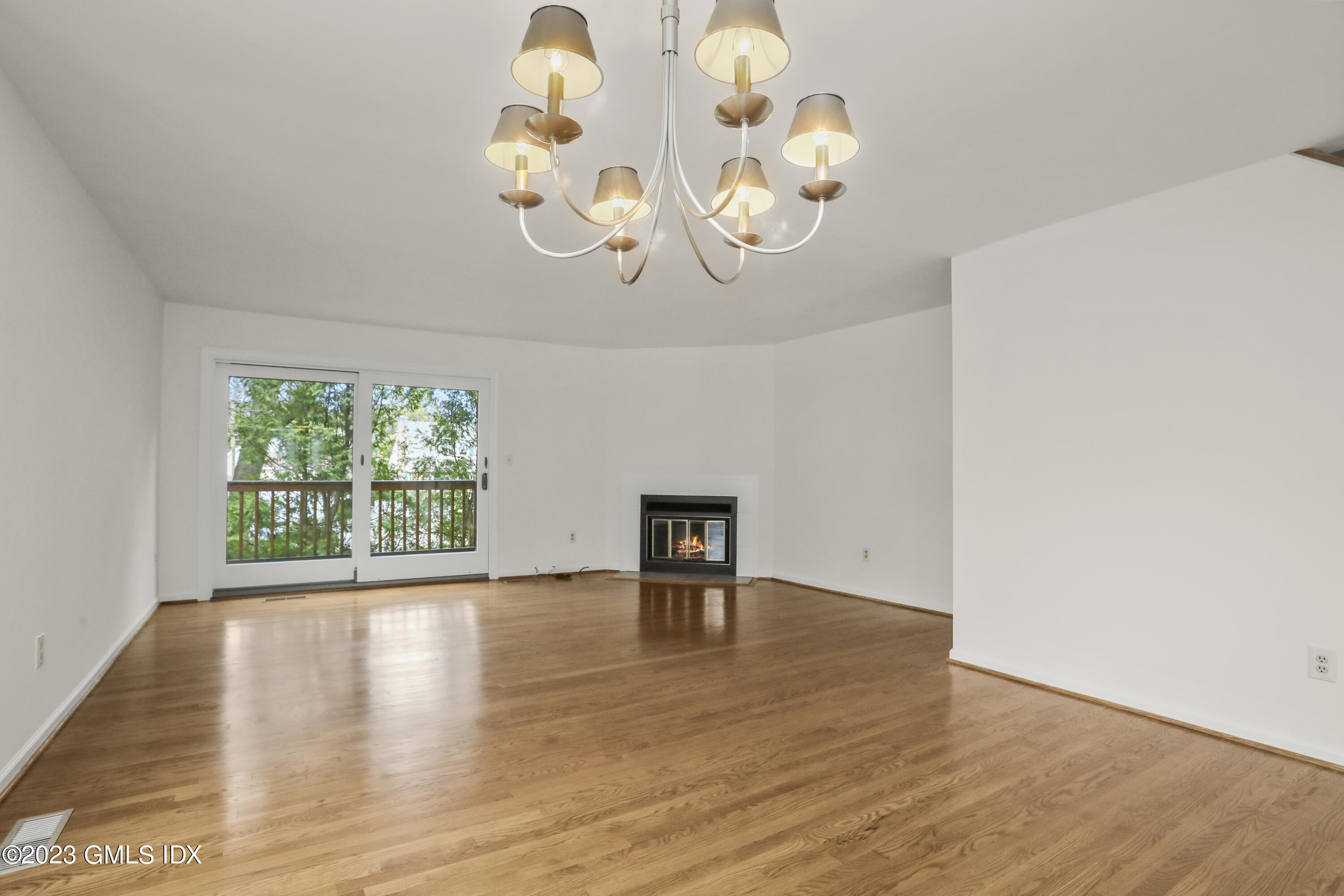 5 Glen Street, Unit 101 Greenwich, CT 06830 - Photo 4 of 37 an empty room with wooden floor and a large window