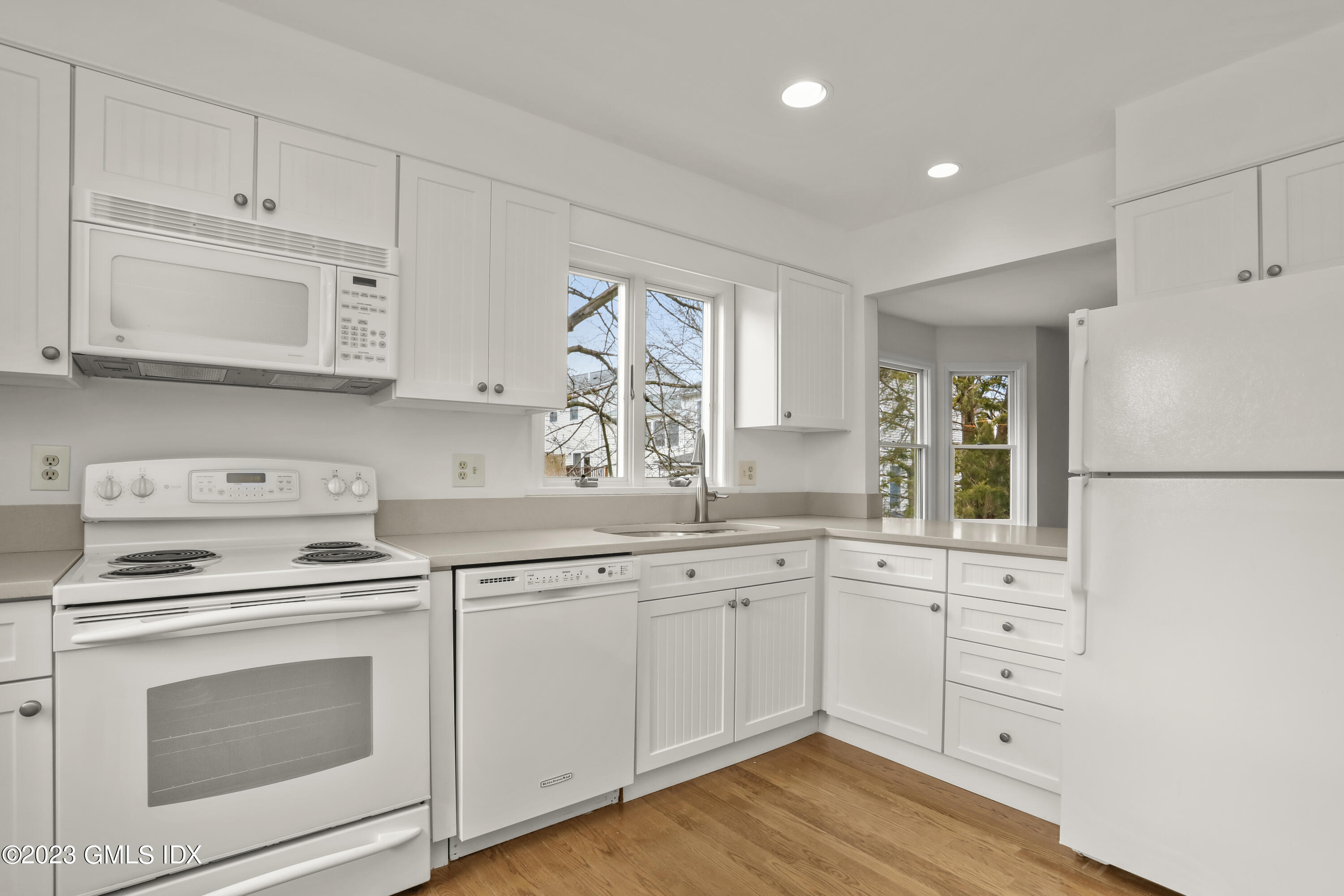5 Glen Street, Unit 101 Greenwich, CT 06830 - Photo 9 of 37 a kitchen with white cabinets and white appliances