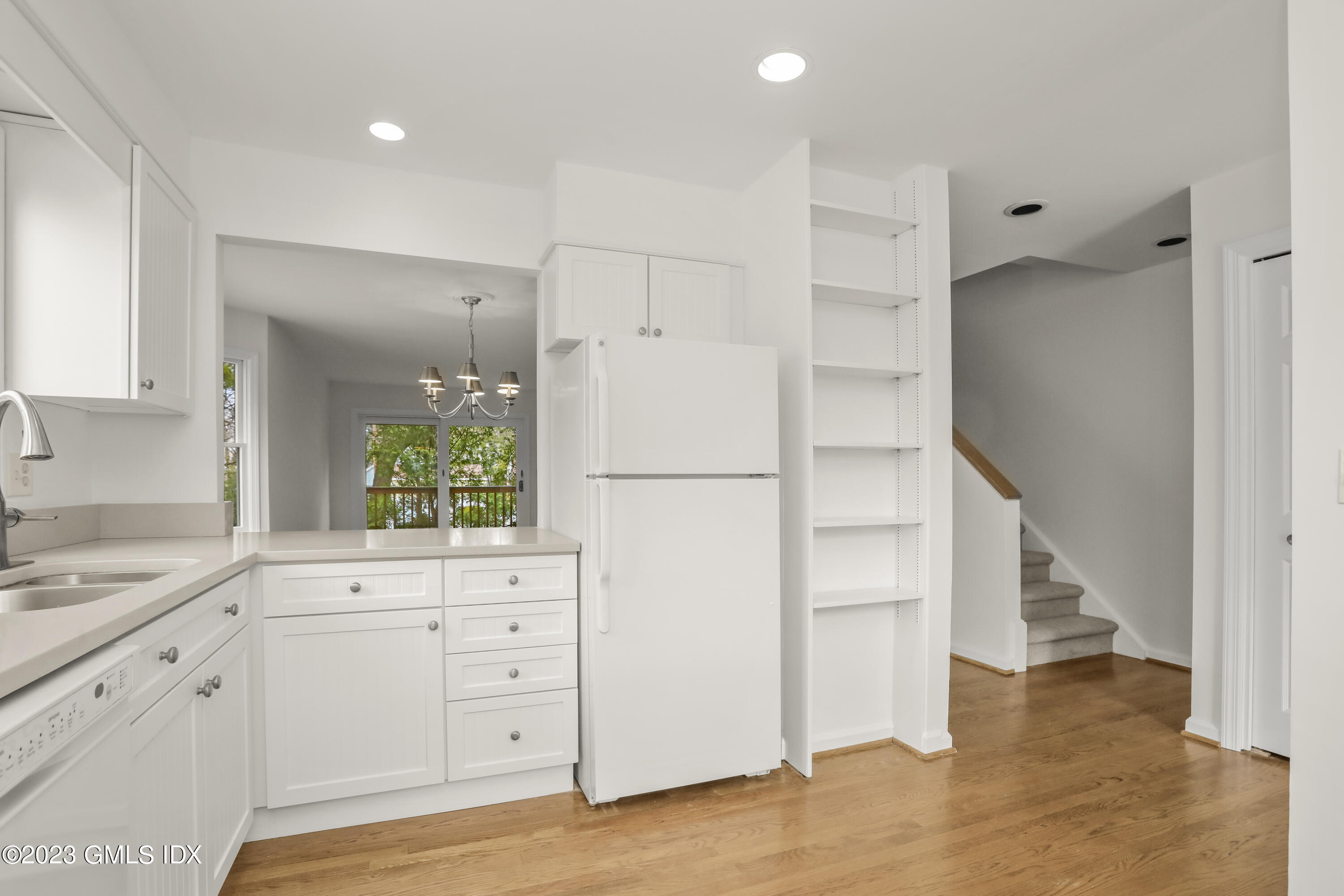 5 Glen Street, Unit 101 Greenwich, CT 06830 - Photo 10 of 37 a kitchen with white cabinets and white appliances