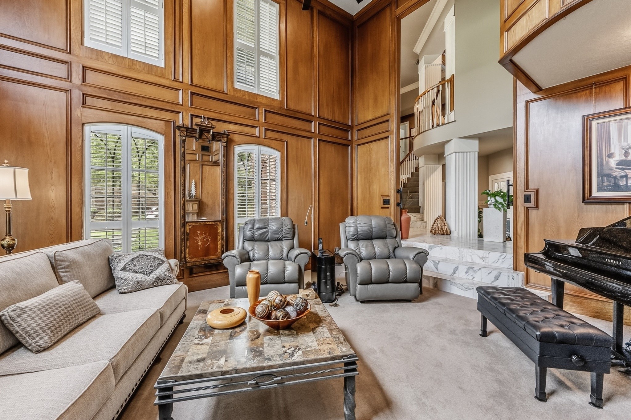 6047 Spring Creek Lane Spring, TX 77379 - Photo 5 of 50 Framed by towering windows and plantation shutters carried throughout much of the home, the living area feels both stately and serene. Thoughtful architectural lines and warm finishes lend a timeless quality that never chases trends.