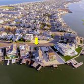 an aerial view of a swimming pool with outdoor seating yard and mountain view in back