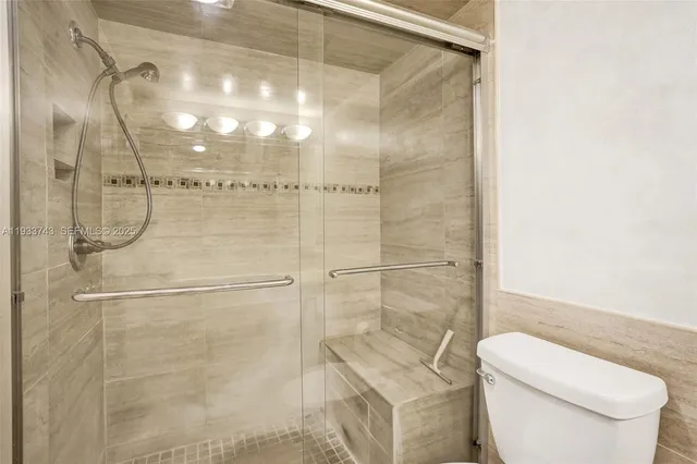 a bathroom with a shower a toilet and sink