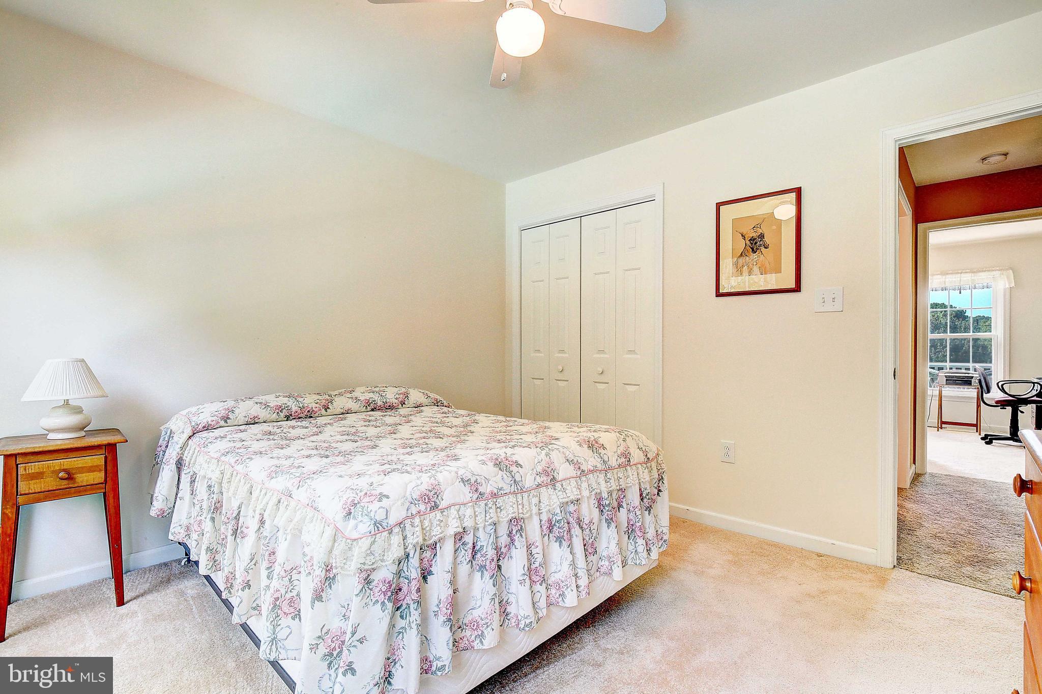 4650 Paul Hance Road Huntingtown, MD 20639 - Photo 17 of 57 a bed sitting in a bedroom next to a window