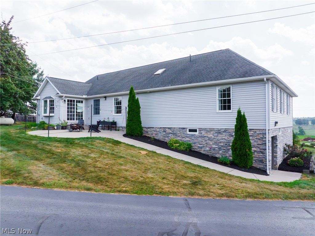 9554 Dover Road Apple Creek, OH 44606 - Photo 12 of 45 Single story home with a patio area, a front yard, roof with shingles, and stone siding