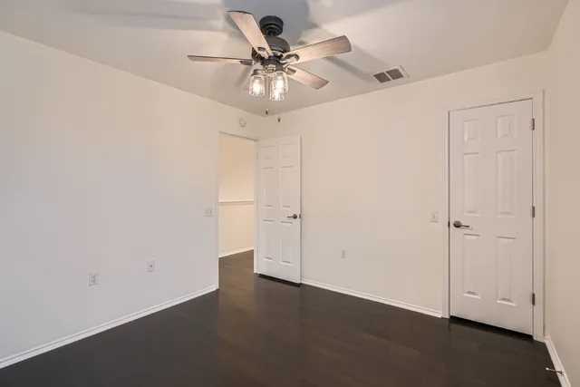 an empty room with a ceiling fan and a ceiling fan