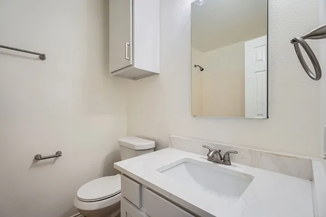 a bathroom with a sink toilet and vanity