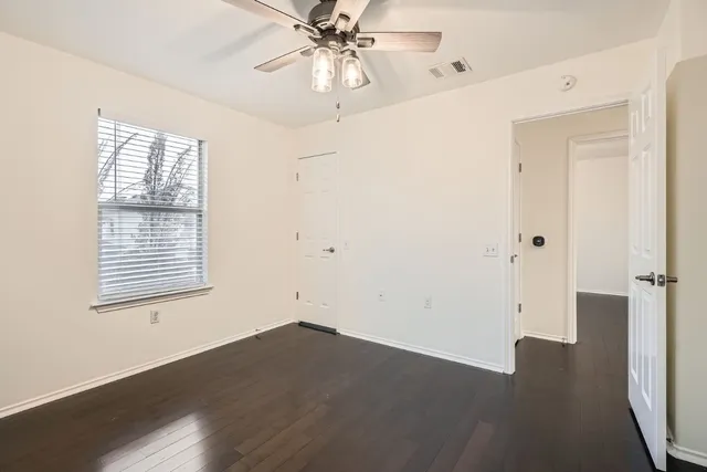 wooden floor in an empty room with a window