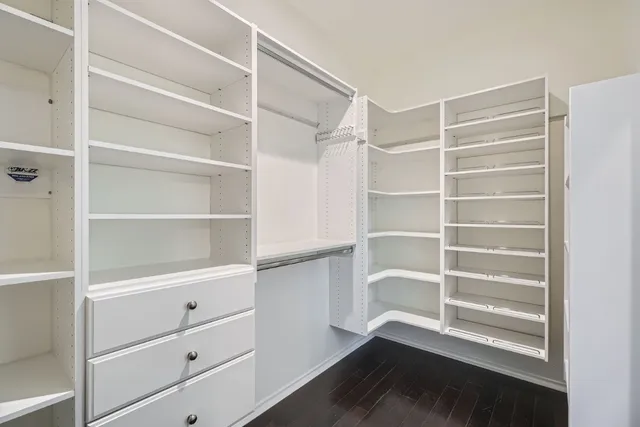 a view of walk in closet with empty racks