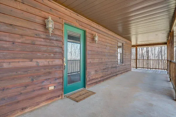 a view of an entryway with wooden floor and door