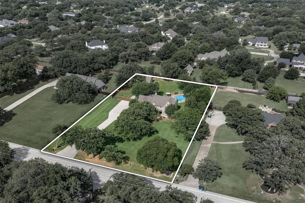 410 Simmons Road Double Oak, TX 75077 - Photo 2 of 40 Aerial view showcasing the generous lot size and mature tree canopy.